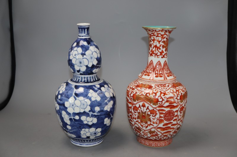 A Chinese blue and white double gourd vase and another vase, tallest 25cm